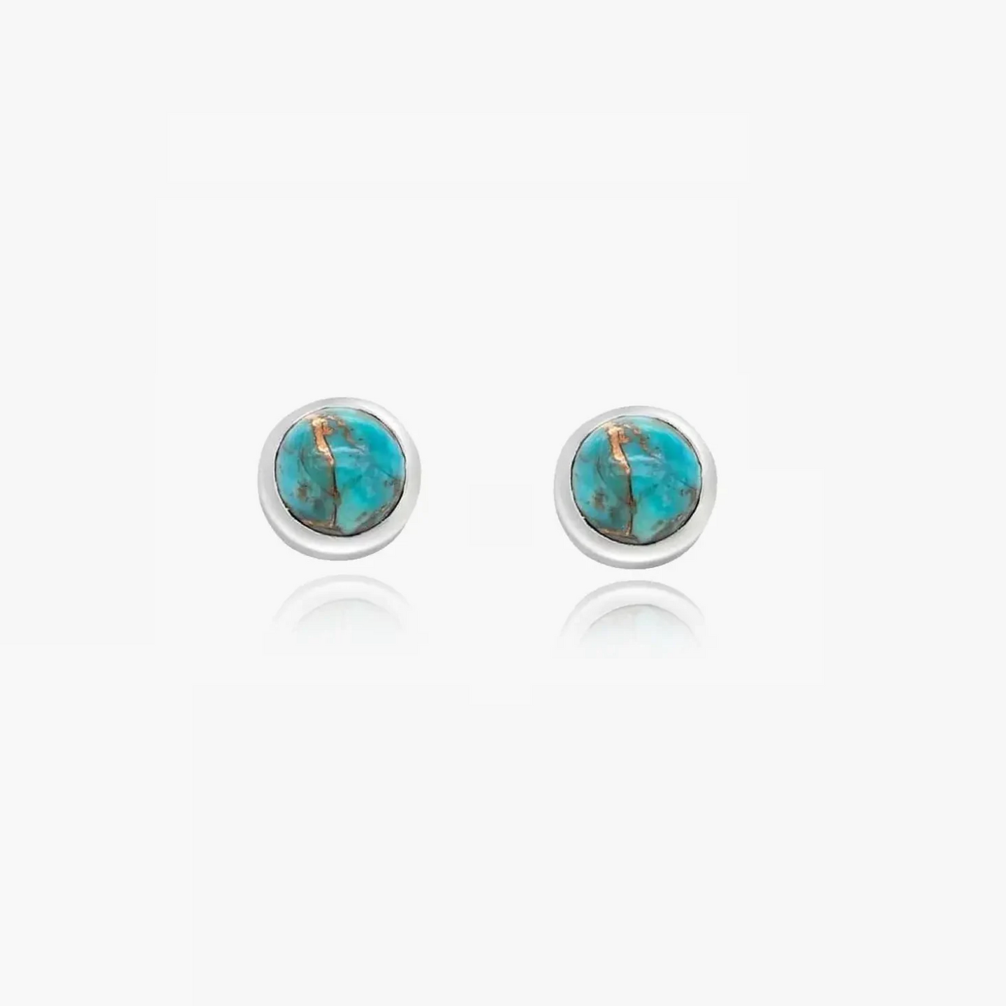 Boucles d'oreilles en argent avec pierres turquoise sur fond blanc.