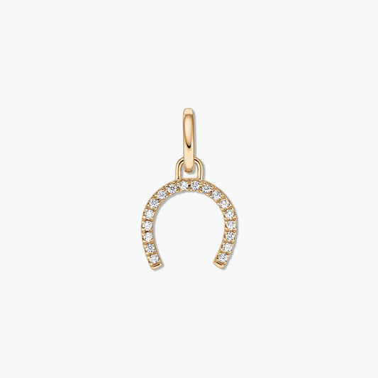 Pendentif fer à cheval en argent doré serti de pierres de zirconium claires sur fond blanc.